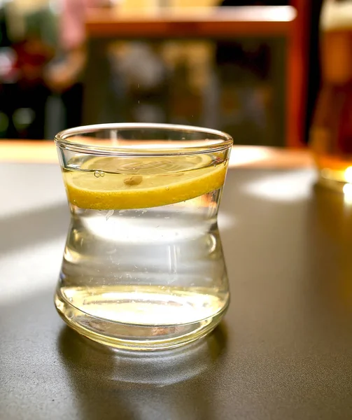 A glass of lemonade stands on a table in a restaurant — ストック写真