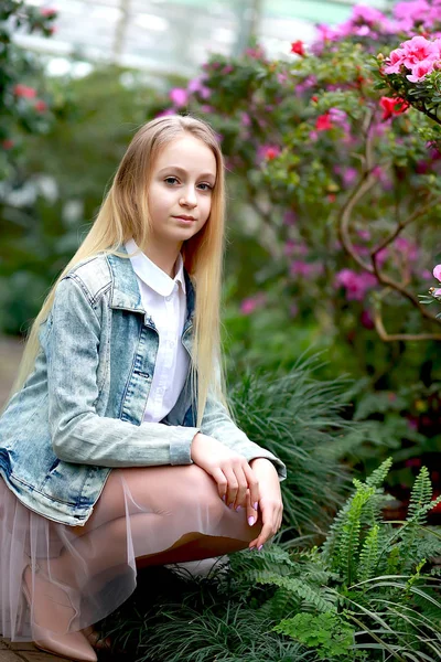 Young girl with long white hair in a hat and a denim jacket walk — 스톡 사진