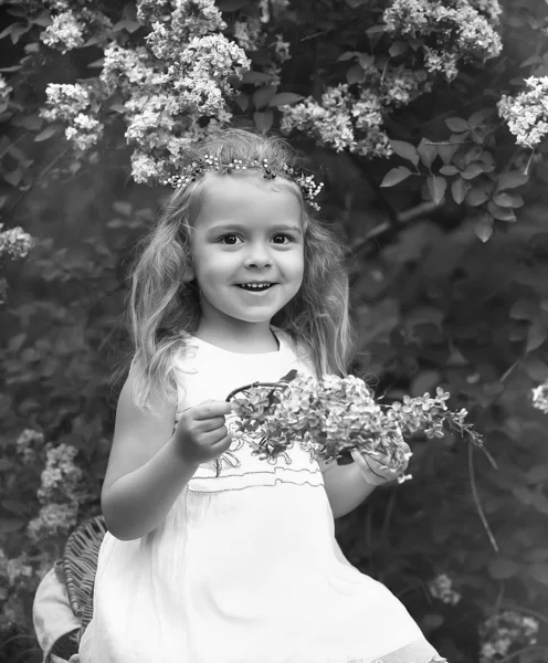 穿着白衣的小女孩走在春天的植物园里 — 图库照片