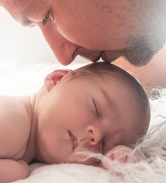 Father gently kisses his newborn baby. Father and son. Happy father's day!