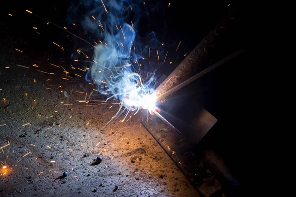 Sparks from welding steel workers.