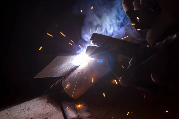 Sparks from welding steel workers.