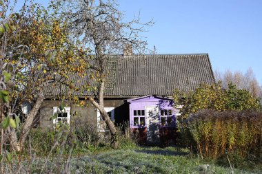 autumn landscape with a house with a backyard