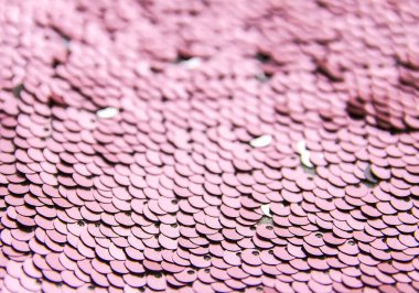 Ilık renklerde parlak, parlak, engebeli pullar. Moda kumaşı arkaplanı.