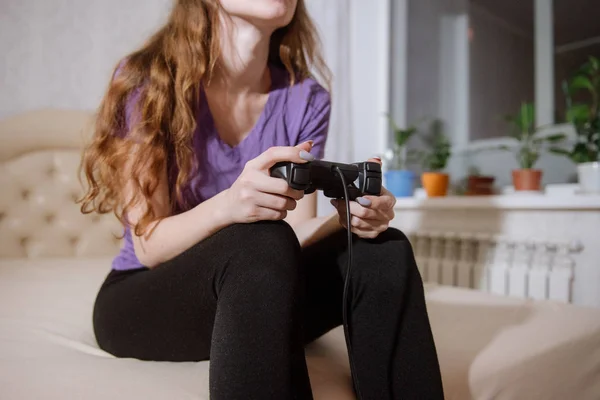 Happy woman playing video games, sitting on bed holding joystick. — Stock Photo, Image