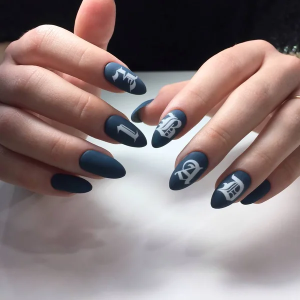 Woman with flesh-colored manicure with design and the inscription BAD, close up — Stock Photo, Image