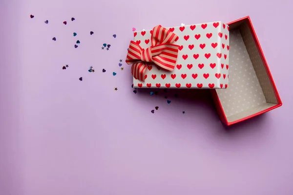 Gift box with beautiful red ribbon on a pink background — 스톡 사진