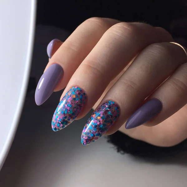 Female hands with women's purple manicure on nails — 스톡 사진