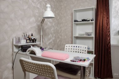 Workplace for manicure in a beauty salon. A cozy place for a manicurist.