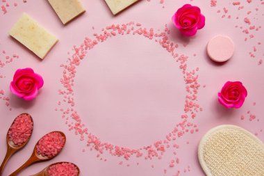 Pembe banyo tuzu, doğal sabun, duş süngeri, tahta kaşıklarda tuz, güller, pembe arka planda banyo bombası. Vücut bakımı konsepti, organik banyo ürünleri. Spa kozmetik. Düz yatıyordu. Boşluğu kopyala.