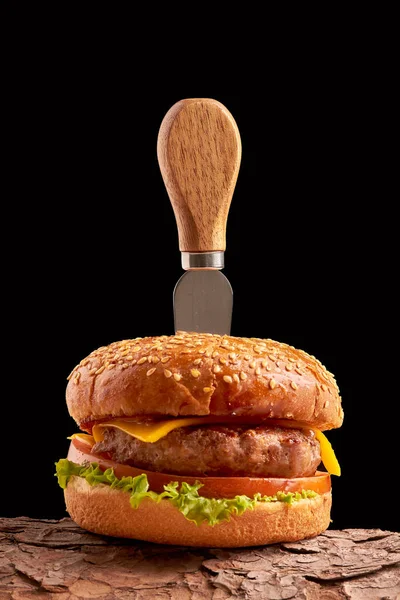 Siyah arka planda ev yapımı hamburger. Taze burger, ahşap kırsal masada. Çizburger..