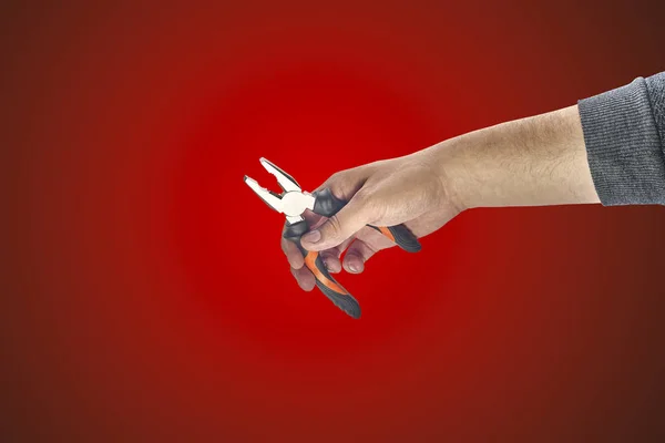 Man's hand holding a pliers — Stock Photo, Image
