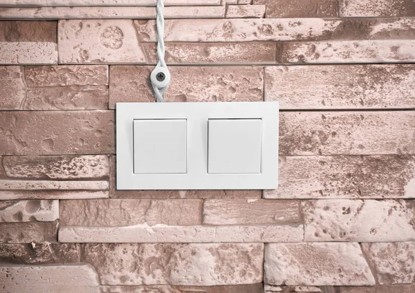 Wires and a switch on a stone wall — Stock Photo, Image