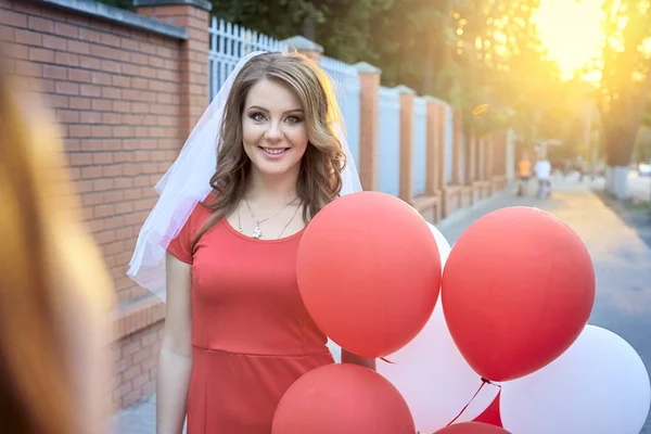 Mooie bruid met ballonnen in het park — Stockfoto