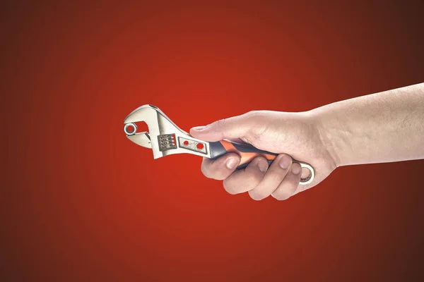 Man's hand holding big wrench — Stock Photo, Image