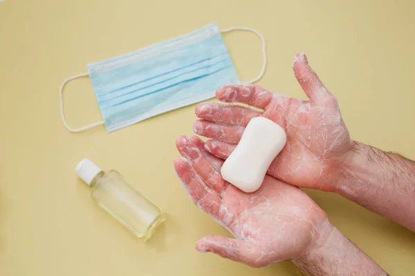 protection during virus outbreak concept: cleaning male hands with a bar of soap