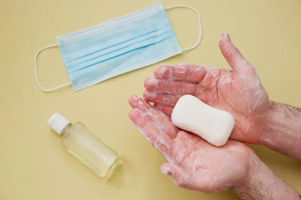protection during virus outbreak concept: cleaning male hands with a bar of soap