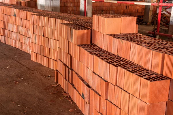 Buildings on the construction site stacked on the square red brick — Stock Photo, Image