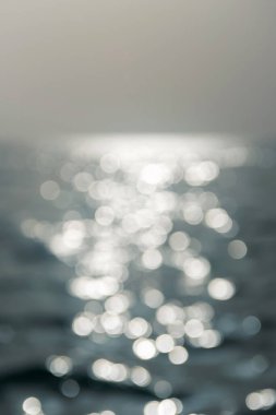 Bulanık su dokusu. Suyun üzerinde güneş parlıyor.