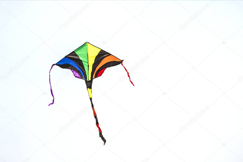 Kite made with colorful cloth flying in the sky. 