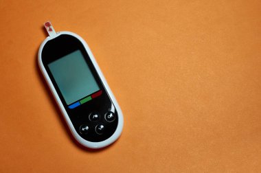 Şeker hastası kan şekerini ölçer. Erkek eli, evinde bir mızrak ve glukometreyle kendini test etti.
