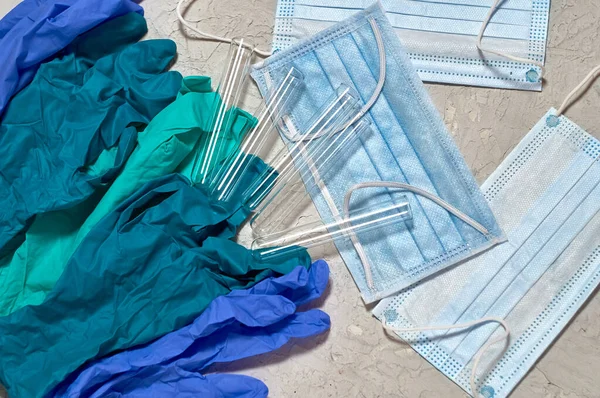 Tıbbi maske, eldivenler, dokulu arka planda test tüpleri..