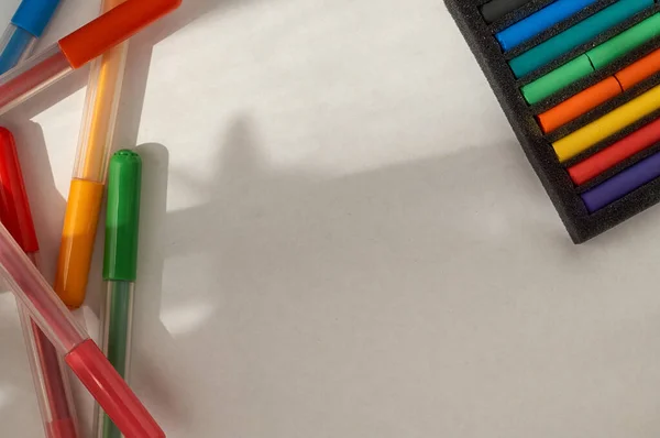drawing with pastels and felt pens. Multi-colored pastel pieces in a package and felt pens