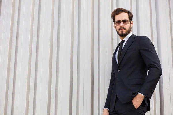 Elegant person in suit with sunglasses outside — Stock Photo, Image