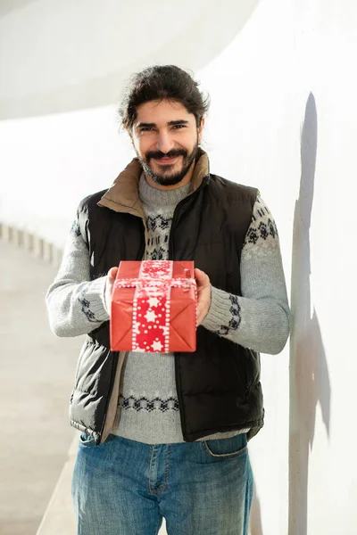 Young man with red gift concept — Stock Photo, Image