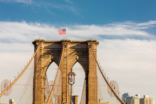 New York City Brooklyn Bridge in Manhattan with united states flag on top