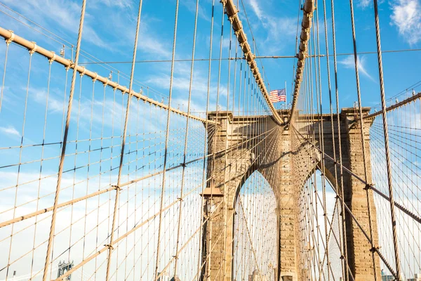 Brooklyn bridge with united states flag on top — Stock Photo, Image