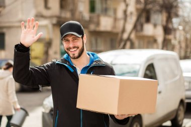 delivery man with cardboard in hands clipart