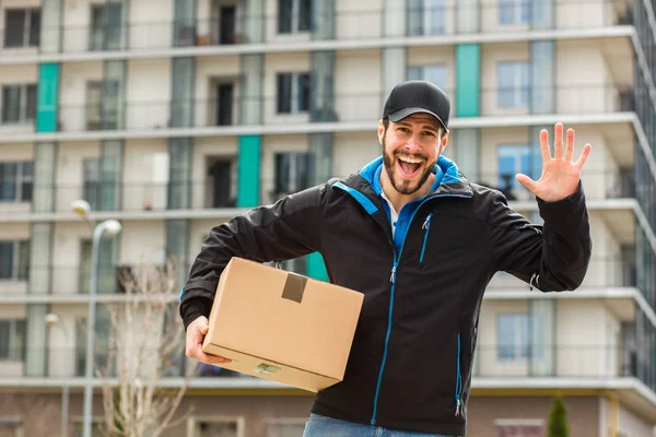 Delivery man with cardboard in hands — Stock Photo, Image