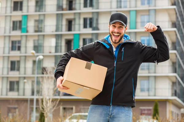 Delivery man with cardboard in hands — Stock Photo, Image