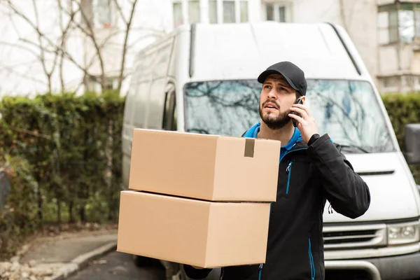 Delivery man with cardboard in hands — Stock Photo, Image