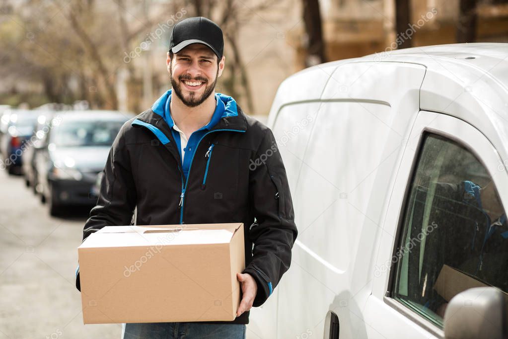 delivery man with cardboard in hands
