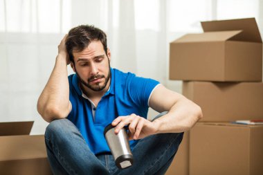 arkasında kutu ambalaj ile yerde yatan adam