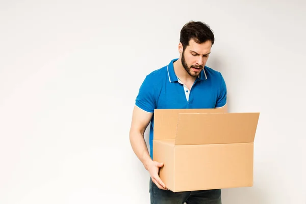 Young man with a cardboard box in his arms — Stock Photo, Image
