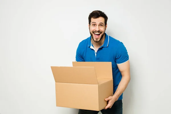 Young man with a cardboard box in his arms — Stock Photo, Image