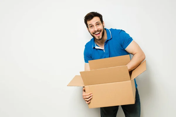 Mladý muž s lepenkovou krabicí v náručí — Stock fotografie