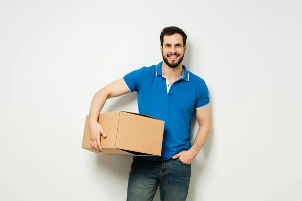 Young man with a cardboard box in his arms — Stock Photo, Image