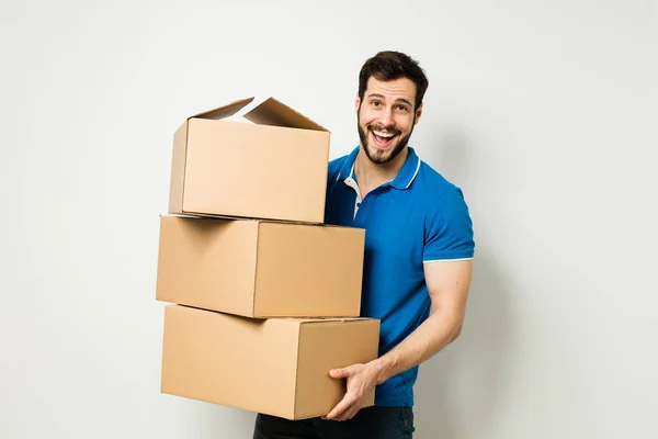 Young man with a cardboard box in his arms — Stock Photo, Image