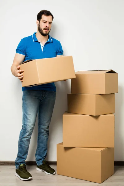 Young man with a cardboard box in his arms — Stock Photo, Image