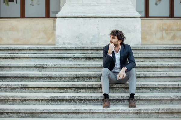 Vuxen och elegant man som satt utanför på trappan — Stockfoto
