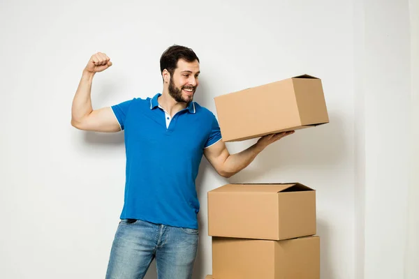 Young man with a cardboard box in his arms — Stock Photo, Image