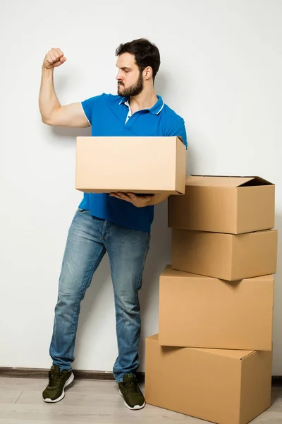 Young man with a cardboard box in his arms — Stock Photo, Image