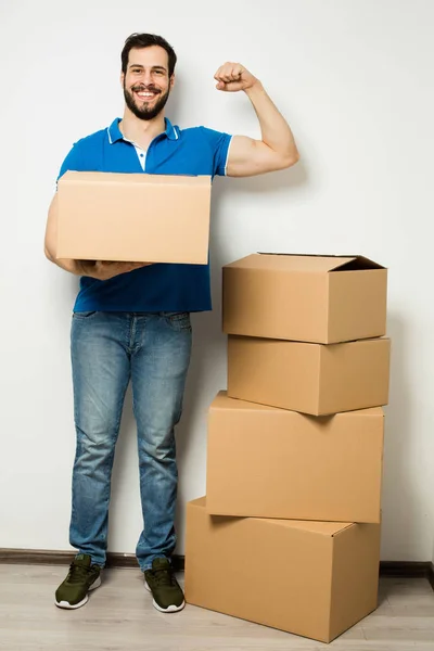 Young man with a cardboard box in his arms — Stock Photo, Image