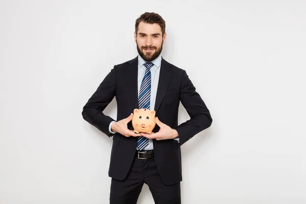 Elegant man with piggy bank on white background — Stock Photo, Image