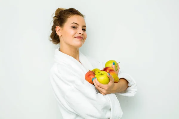 Mulher em toalha de banho branca segurando maçã nas mãos — Fotografia de Stock