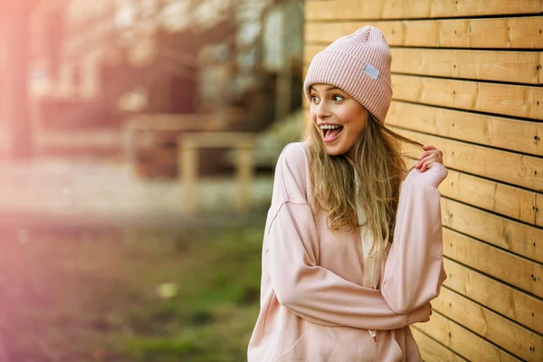 Fresco joven mujer en rosa sudadera con capucha sobre fondo de madera — Foto de Stock